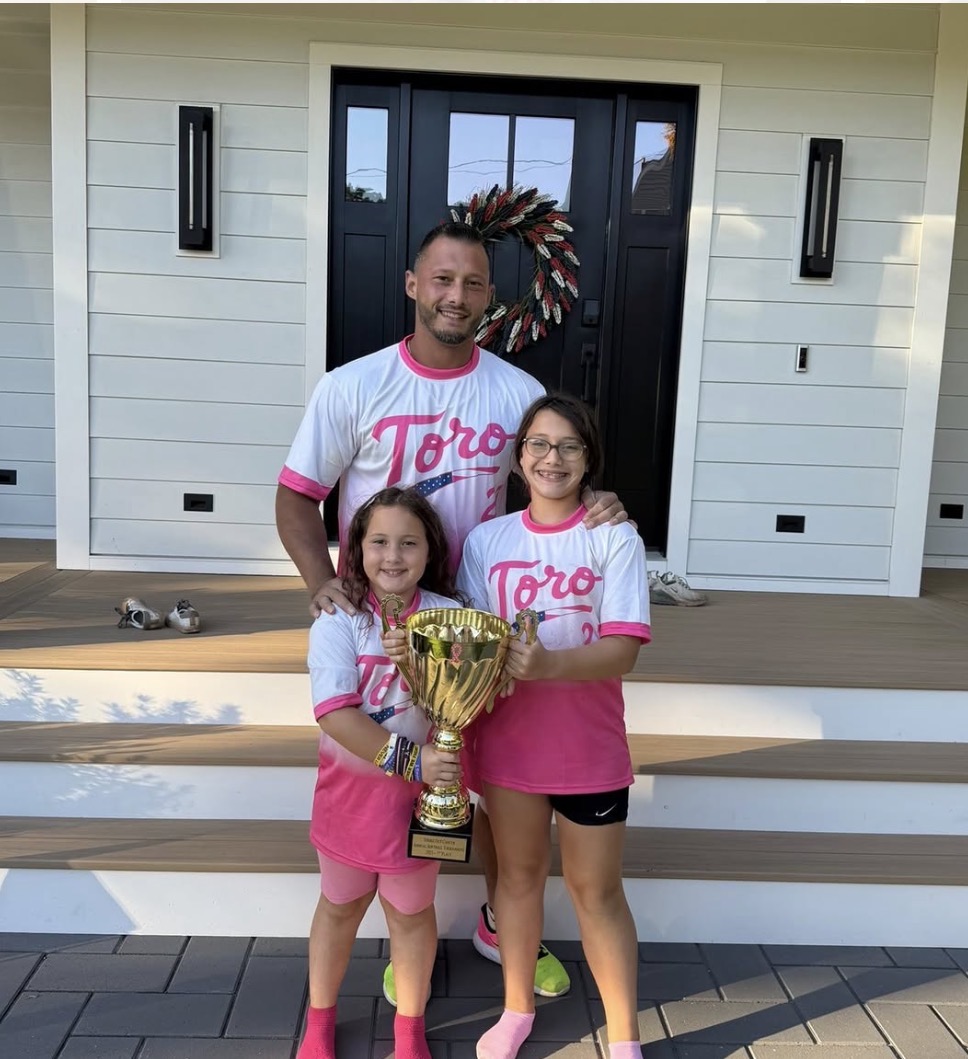 Toro Construction softball sponsor with young players and trophy