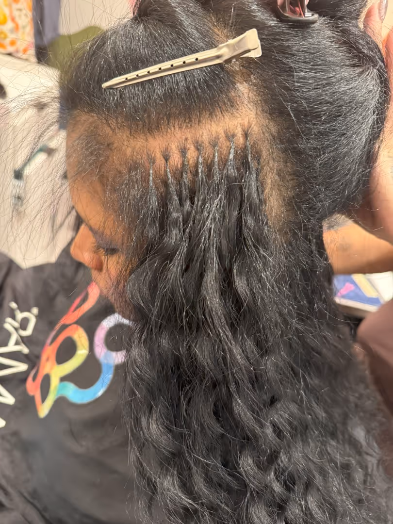Great Lengths keratin bond extension melting technique on brunette hair showing flexible bond formation Denver area