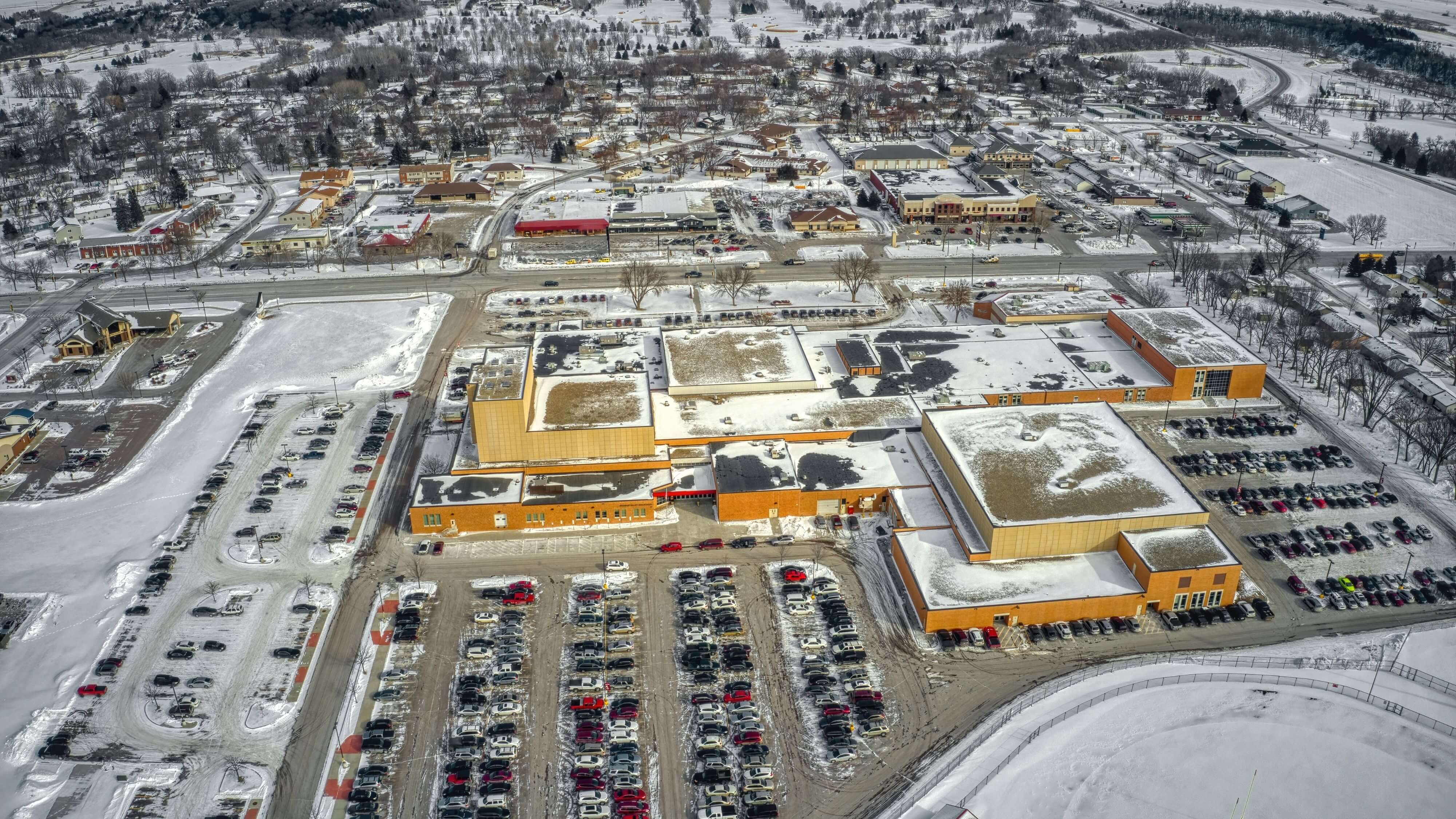 Aerial view of a commercial area in Sioux Falls, SD during winter, ideal for holiday and permanent lighting installations by 605 Holiday Lighting