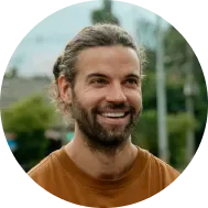 smiling man in orange shirt