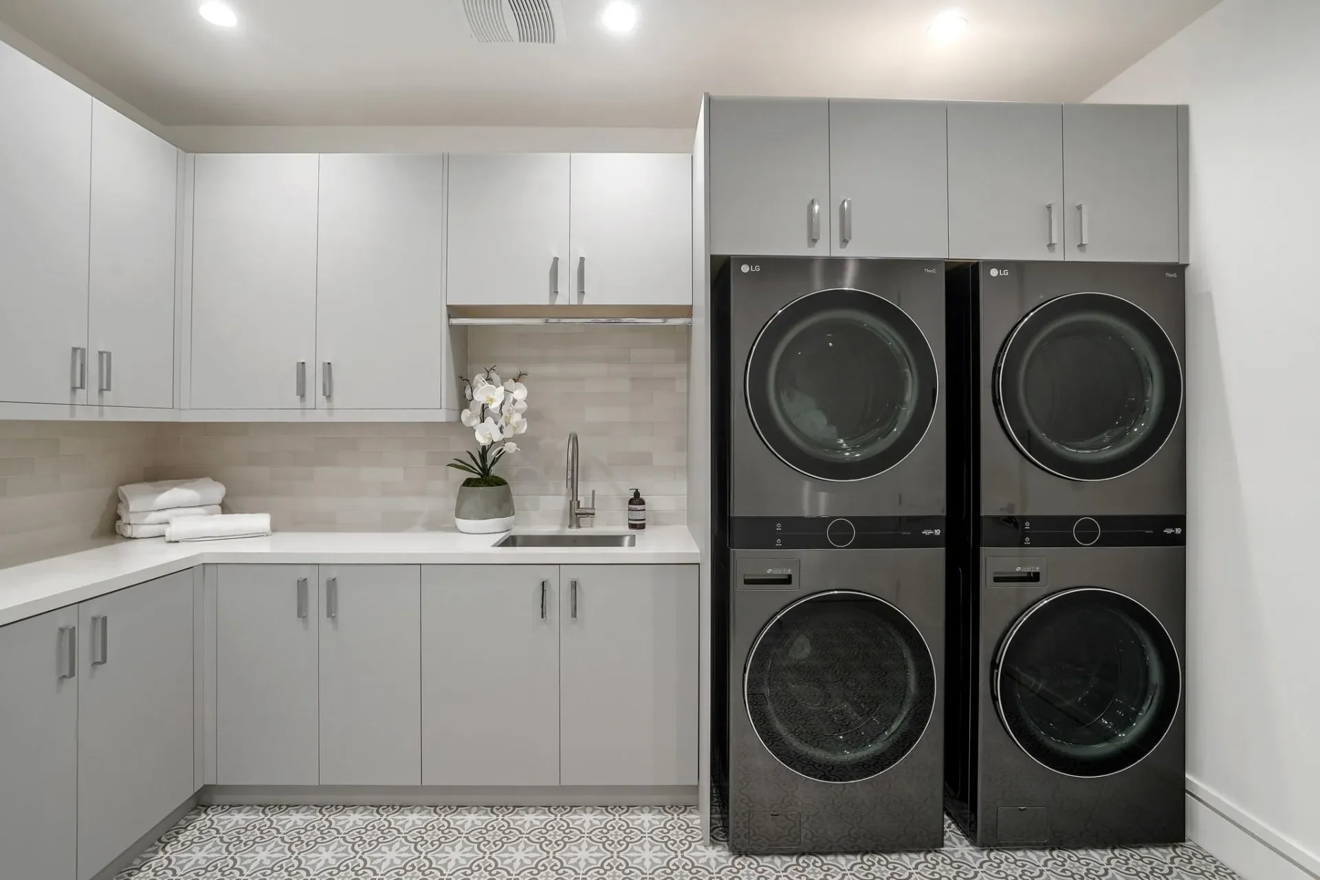 Laundry room with stacked appliances at South Bundy Drive.