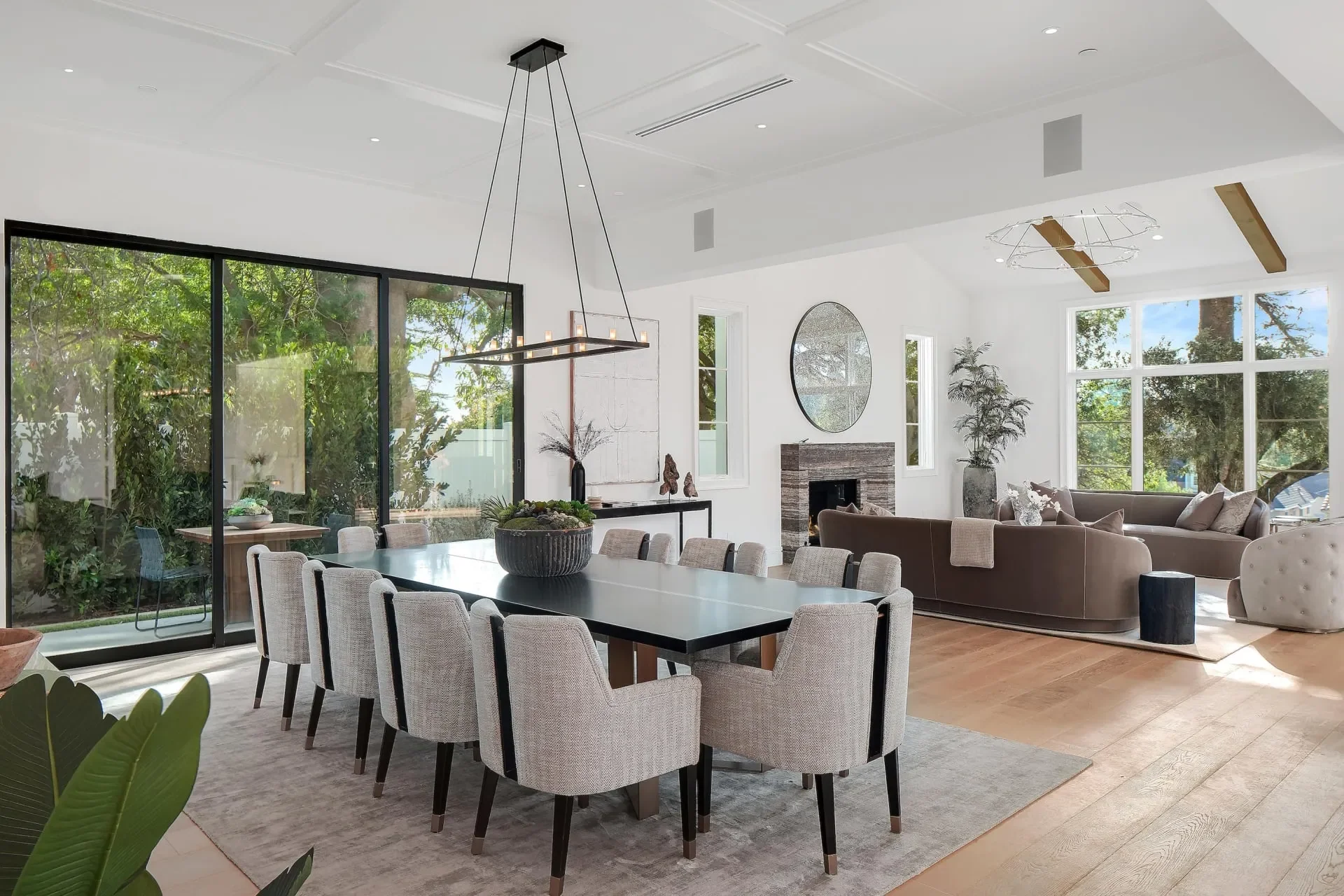 Dining table beside full-height glazing at South Bundy Drive.