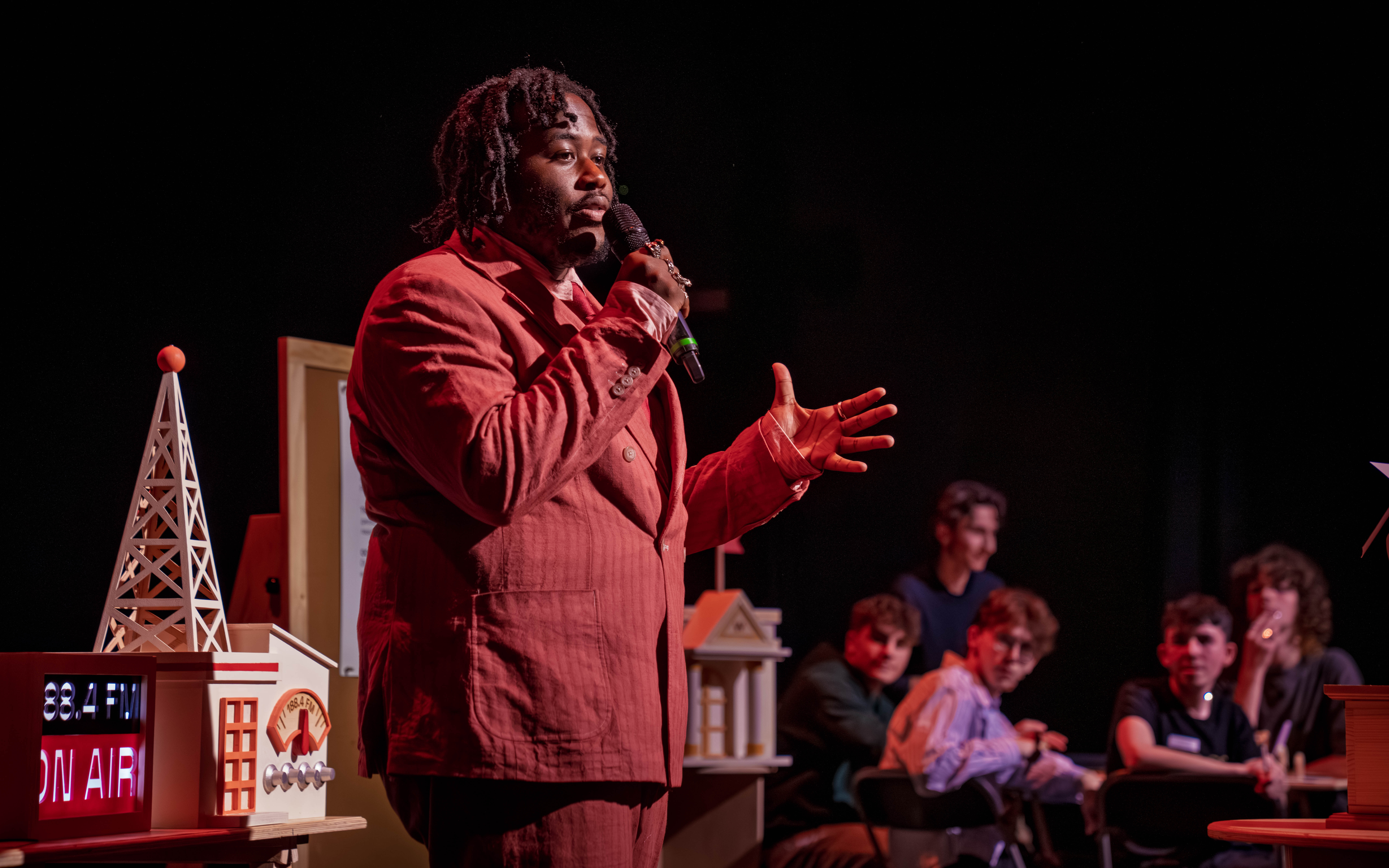 A man dressed in red holding a microphone
