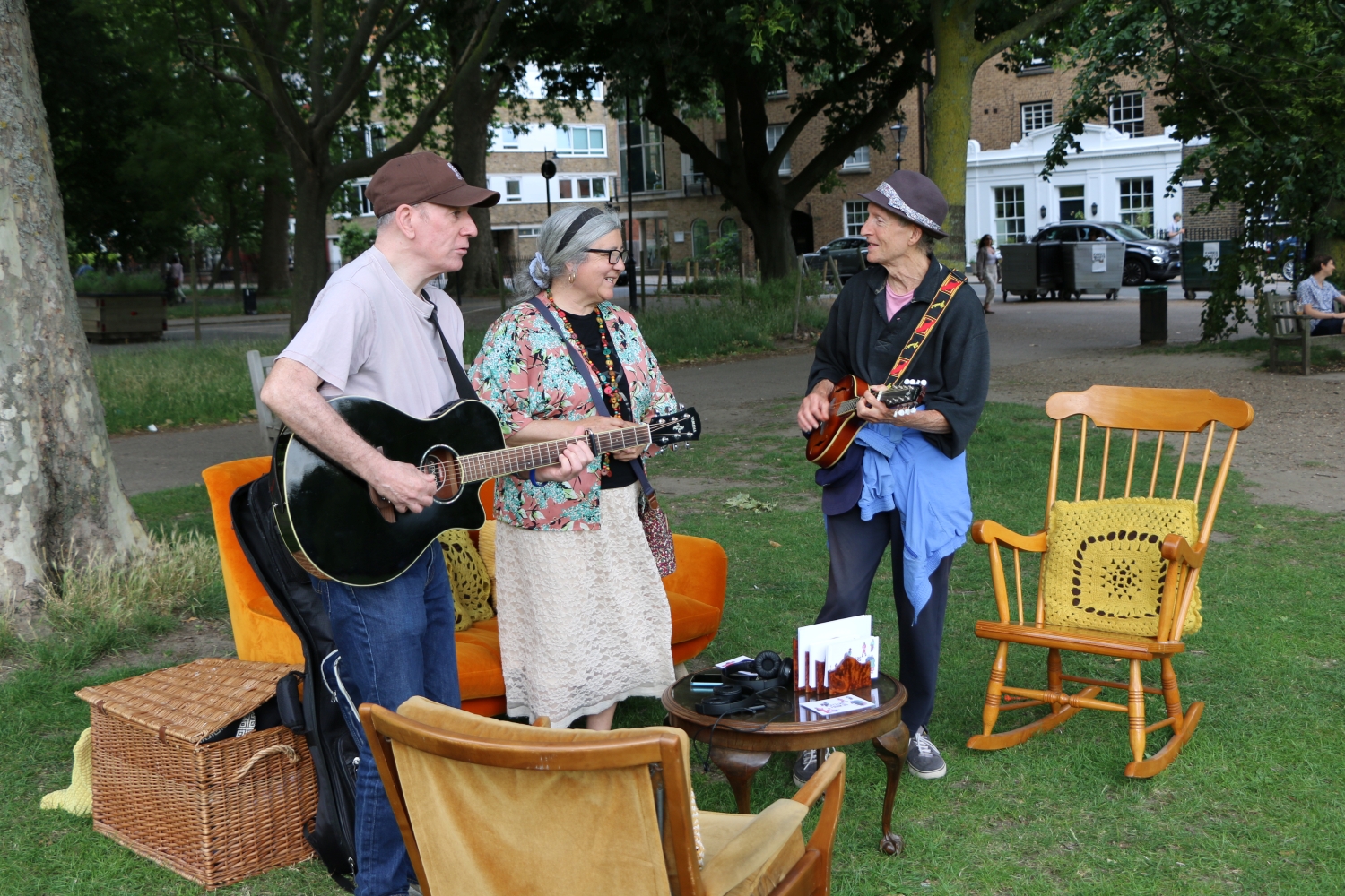 Three musicians playing in an outdoor living room