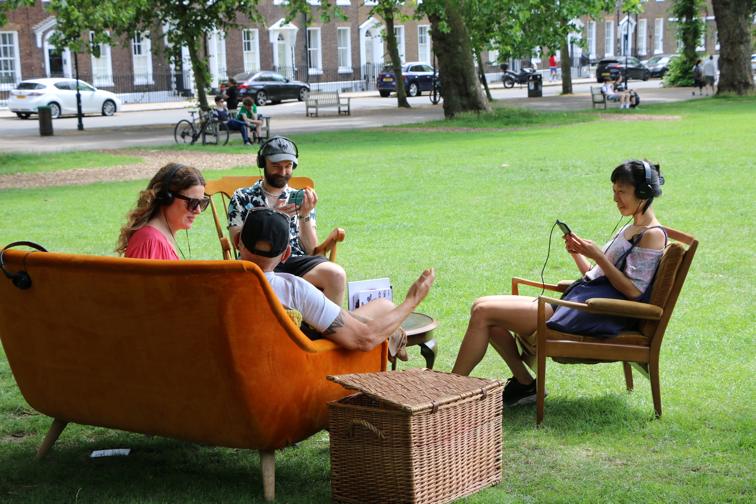 Audience members in an outdoor vintage living room