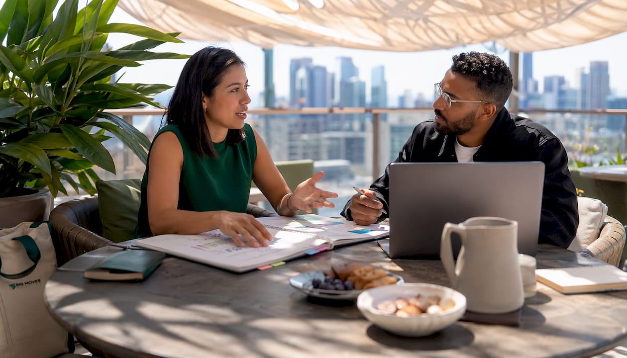 Two professionals collaborating on marketing campaign