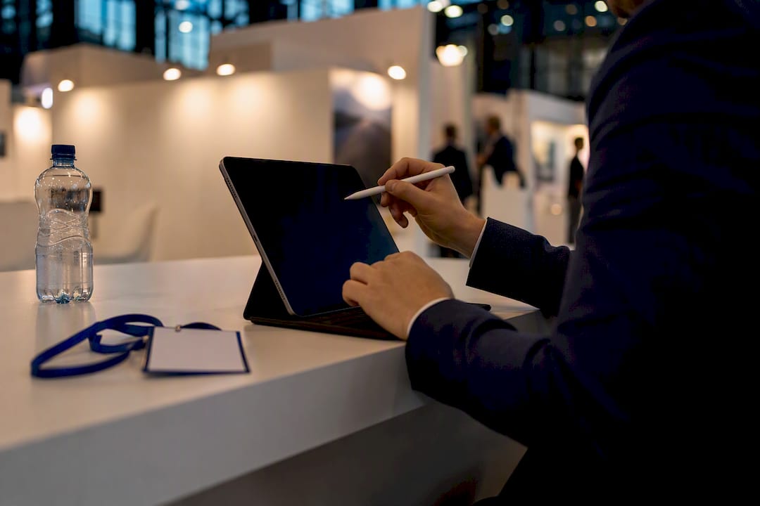 Hand assigning lead tier with stylus at booth