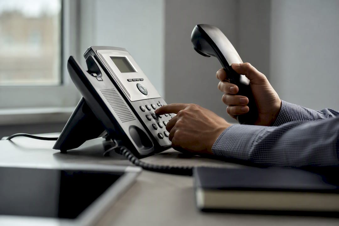 Close-up of hands dialing phone