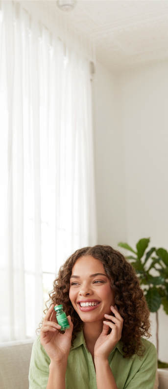 Green vial labeled 'ivy GLP-1 Injection Rx only' floating above a matching green surface.