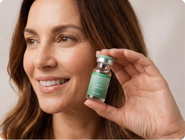 Smiling woman with curly hair holding a small vial labeled 'ivy GLP-1 Injection Rx only' against a teal background.