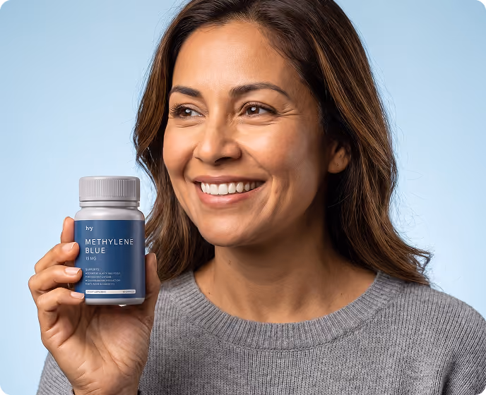 Smiling woman holding a bottle of Methylene Blue supplement with a blue label.