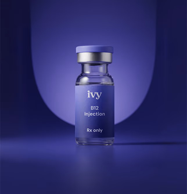 A small glass vial with a purple cap and label, branded 'ivy', containing B12 injection medication with the text 'Rx only' on the label, set against a purple gradient background.