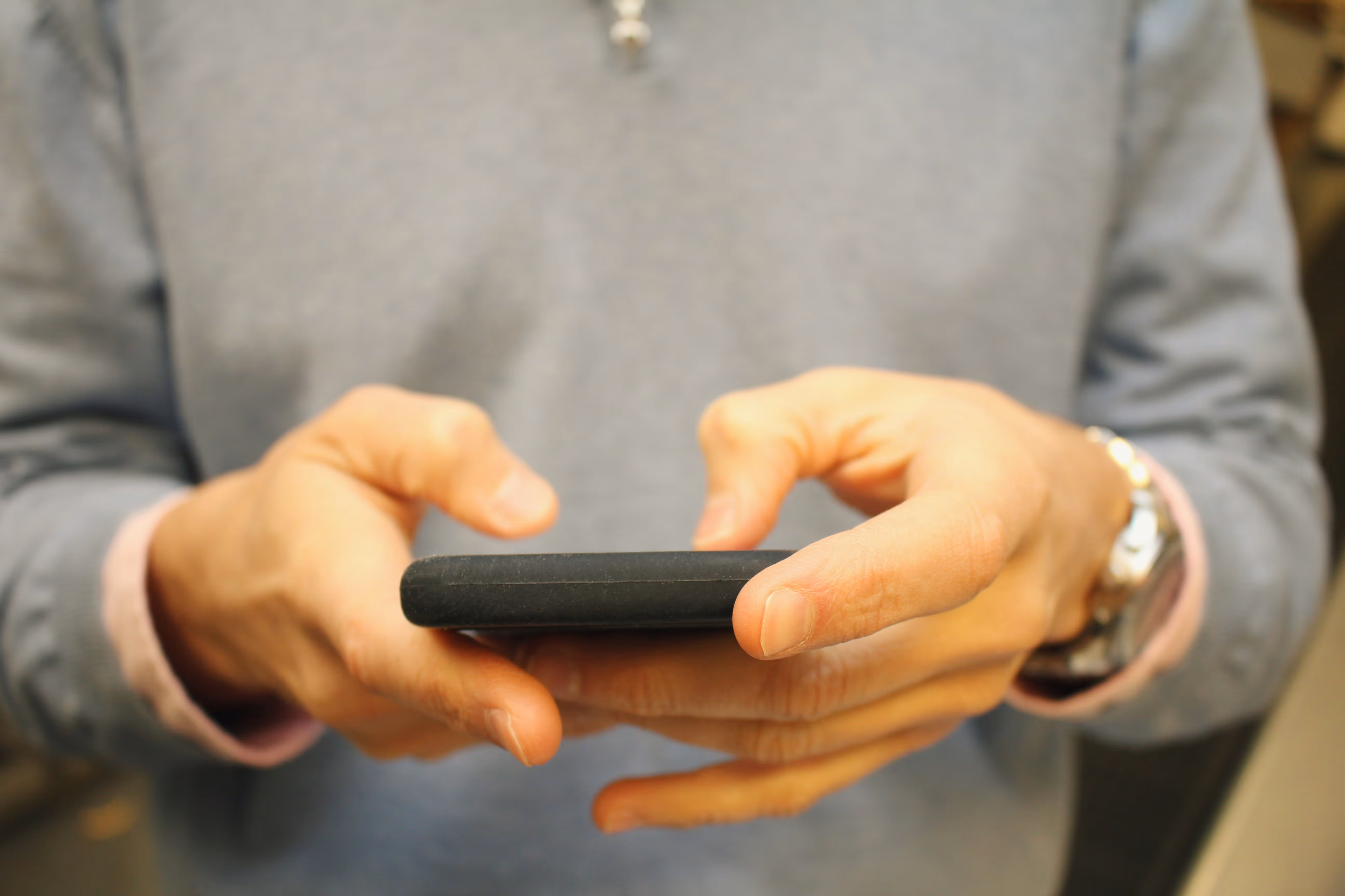 Person texting on smart phone