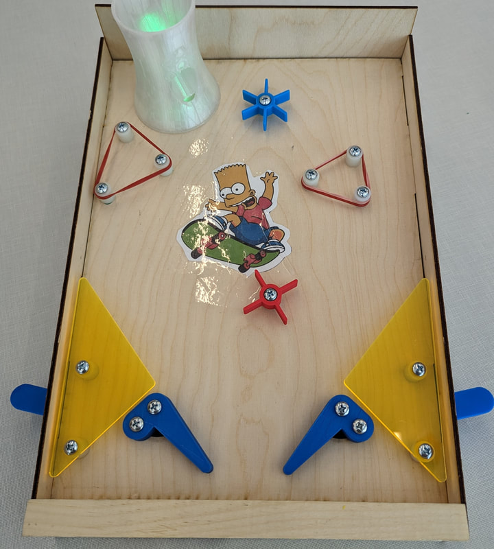 Wooden pinball game featuring a sticker of Bart Simpson skateboarding, blue and red spinners, two yellow flippers, and triangular bumpers with red rubber bands.