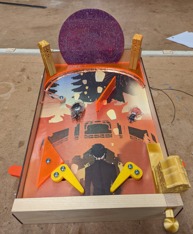 Handcrafted pinball machine featuring anime-themed artwork and characters, with orange flippers and yellow accents on a wooden frame.