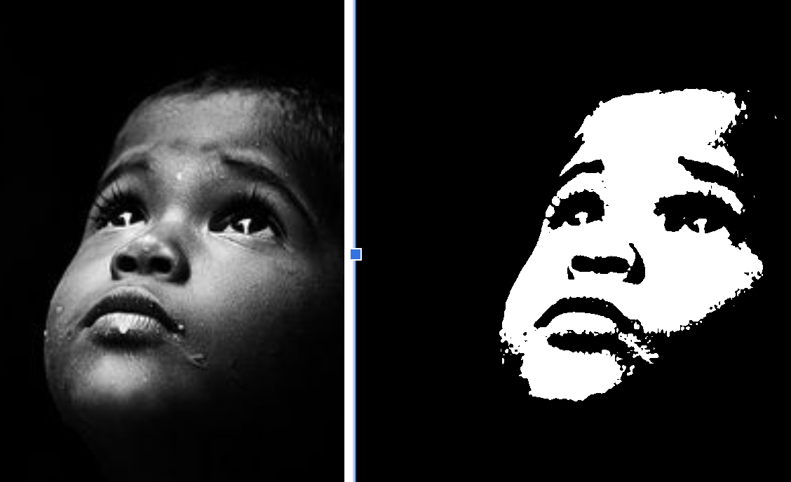 Black and white portrait of a young child looking upwards with a contemplative expression.