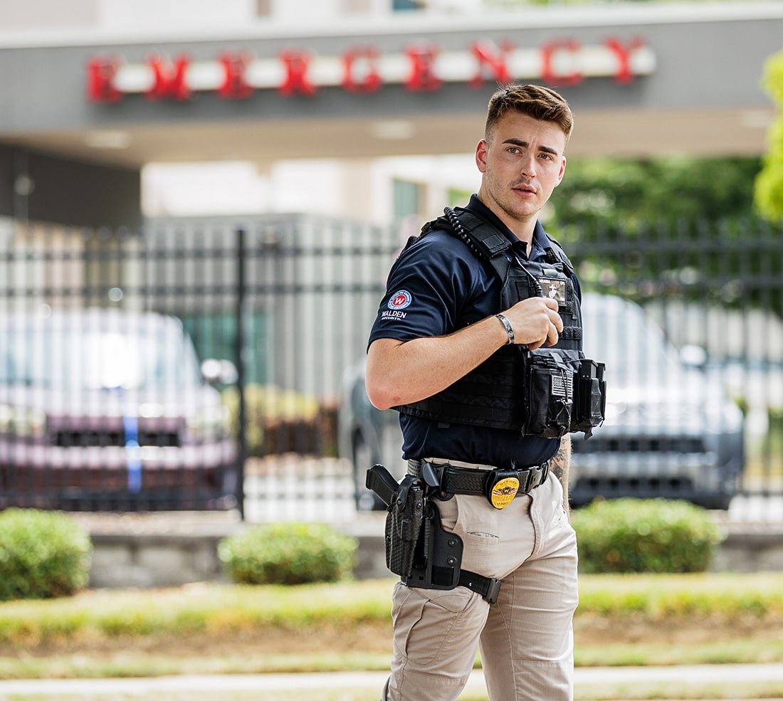three security guards standing proud for Walden Security.