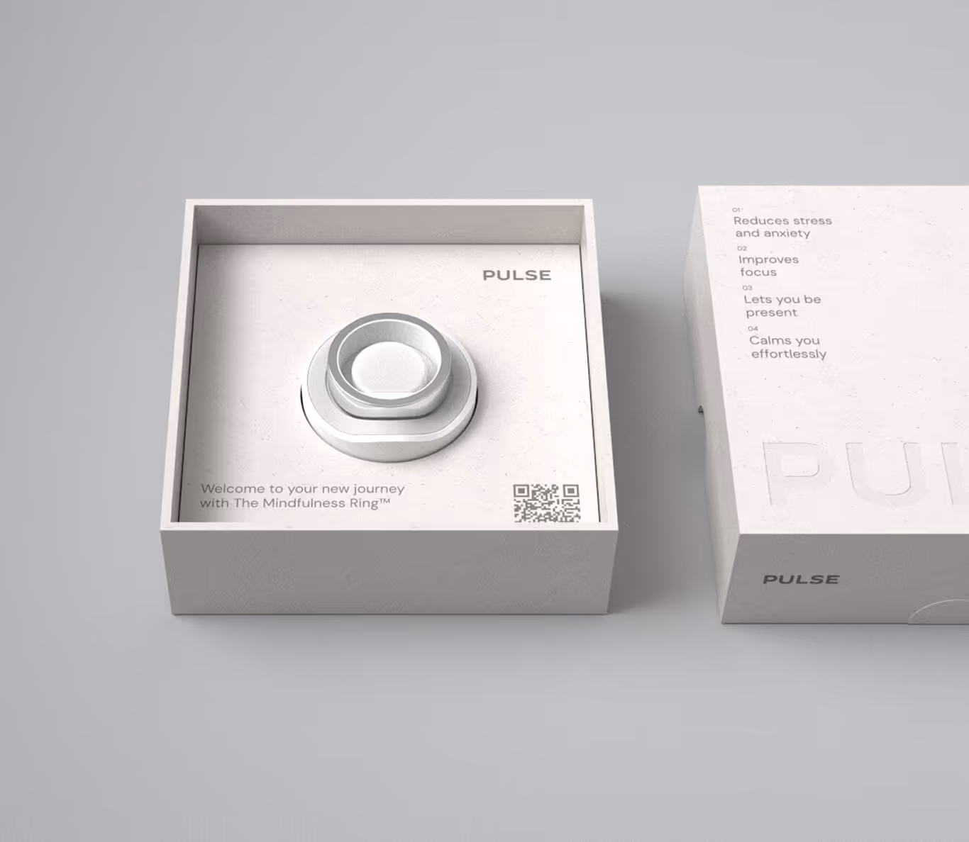 Open box with a silver Mindfulness Ring and a lid listing benefits like reducing stress and improving focus.