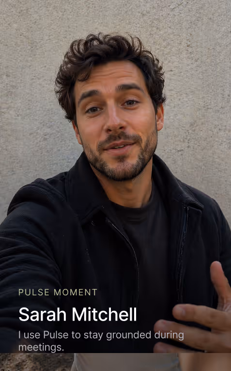 Man in black jacket gesturing in front of a gray wall with text about Pulse and Sarah Mitchell.