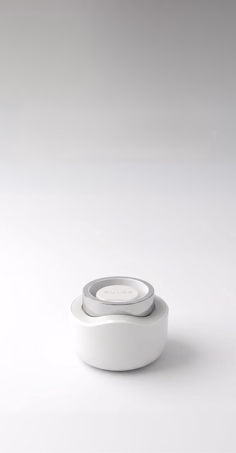 Minimalist white and silver device with the word PULSE on top, placed on a white surface.
