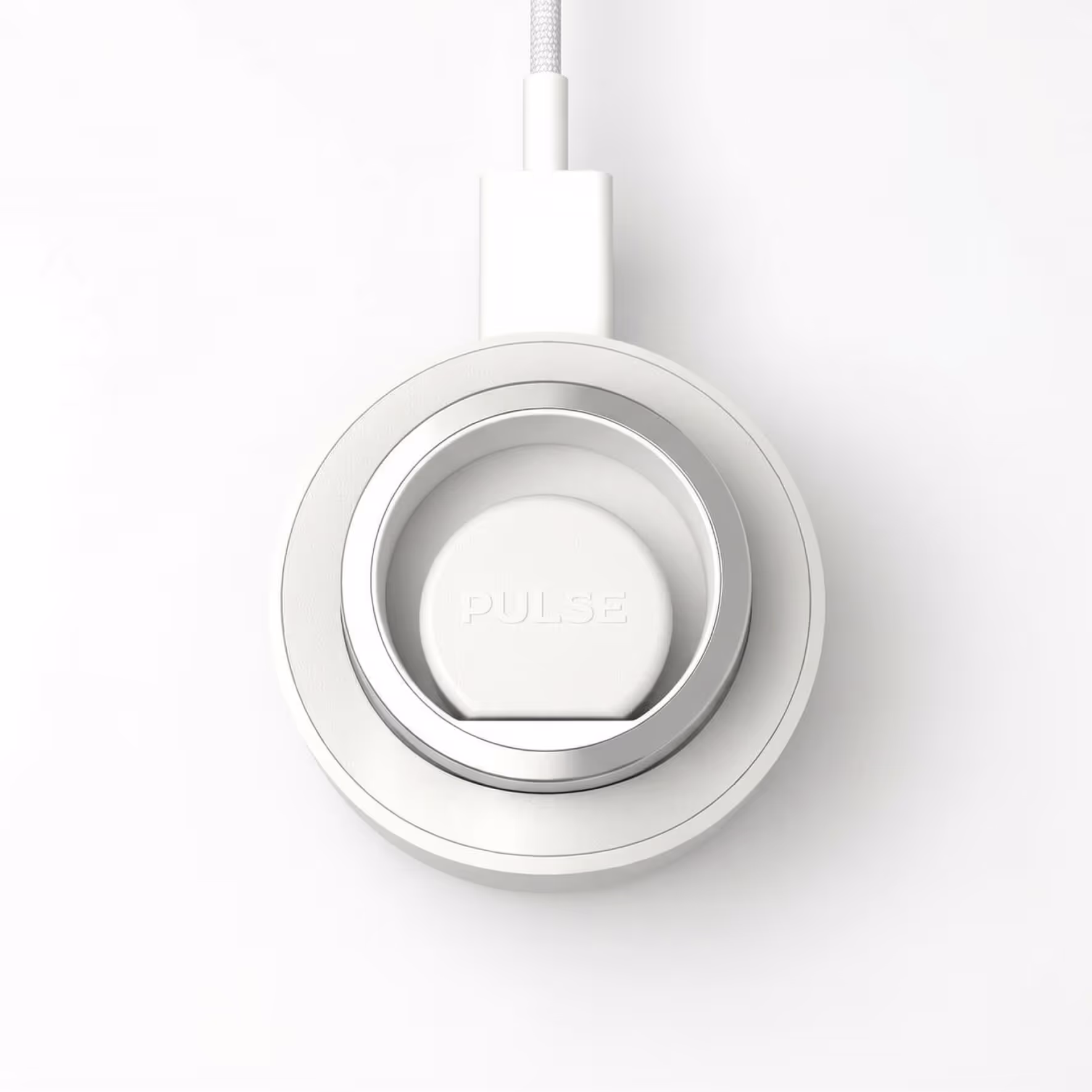 White circular Pulse charger with silver ring and attached braided cable on a white background.
