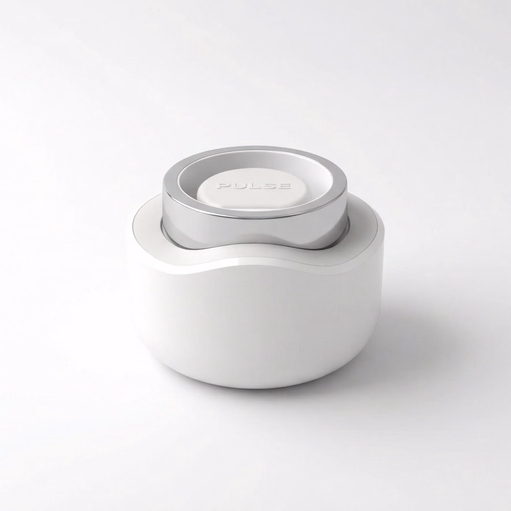 White and silver circular device with the word PULSE embossed on top against a white background.