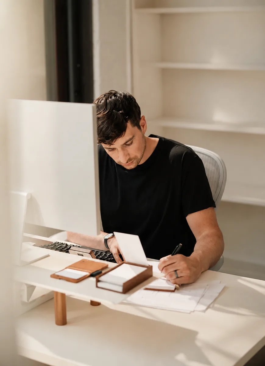 A man writing notes at a desk