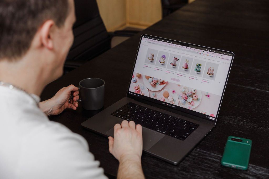 FireNet developer reviewing a Shopify storefront on a laptop.
