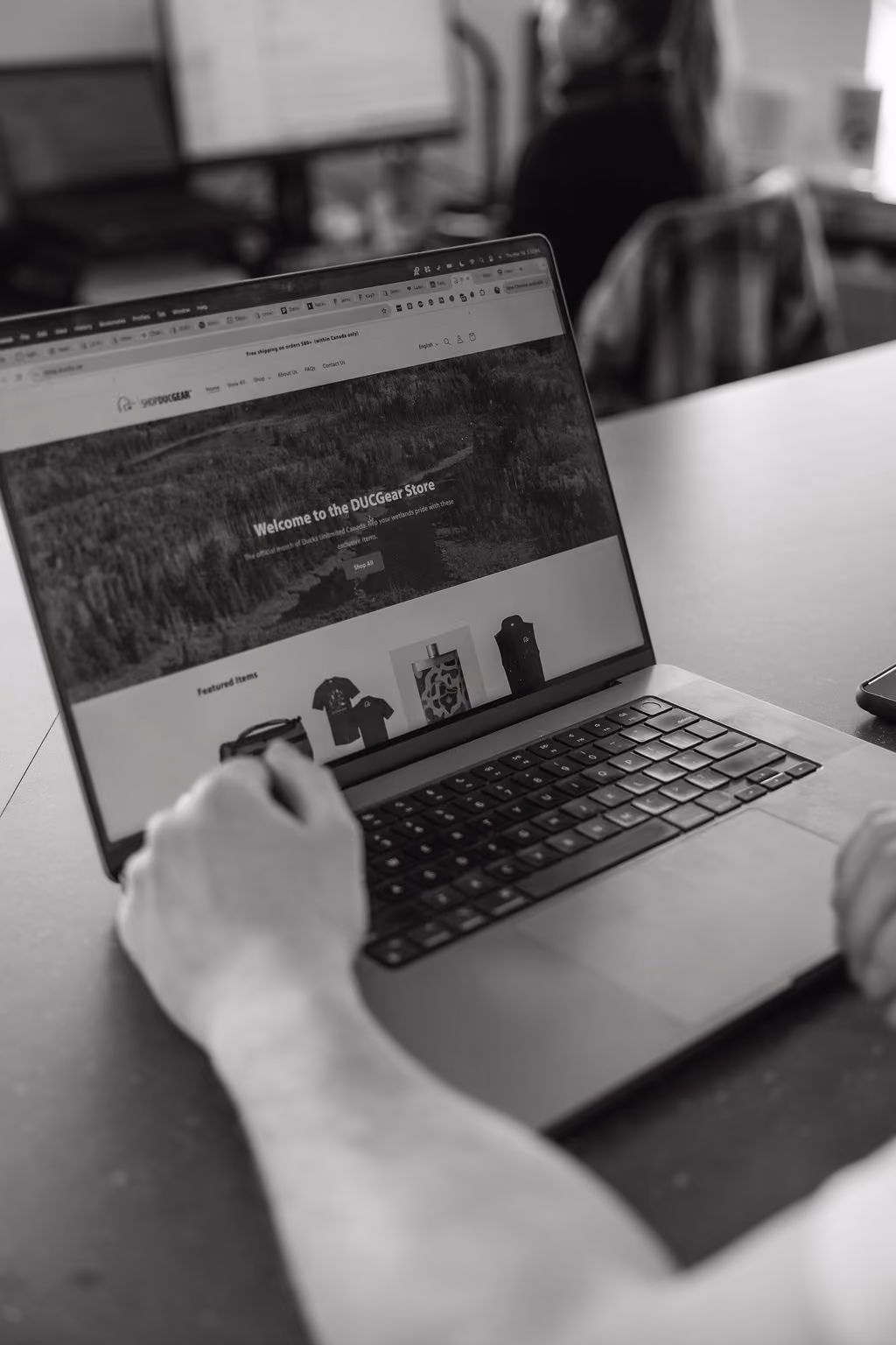 FireNet developer reviewing a Shopify product page on a laptop.