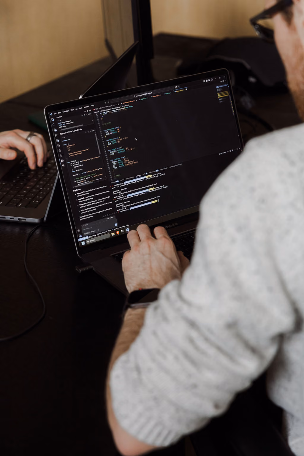 FireNet developer coding a custom Shopify build on a laptop.