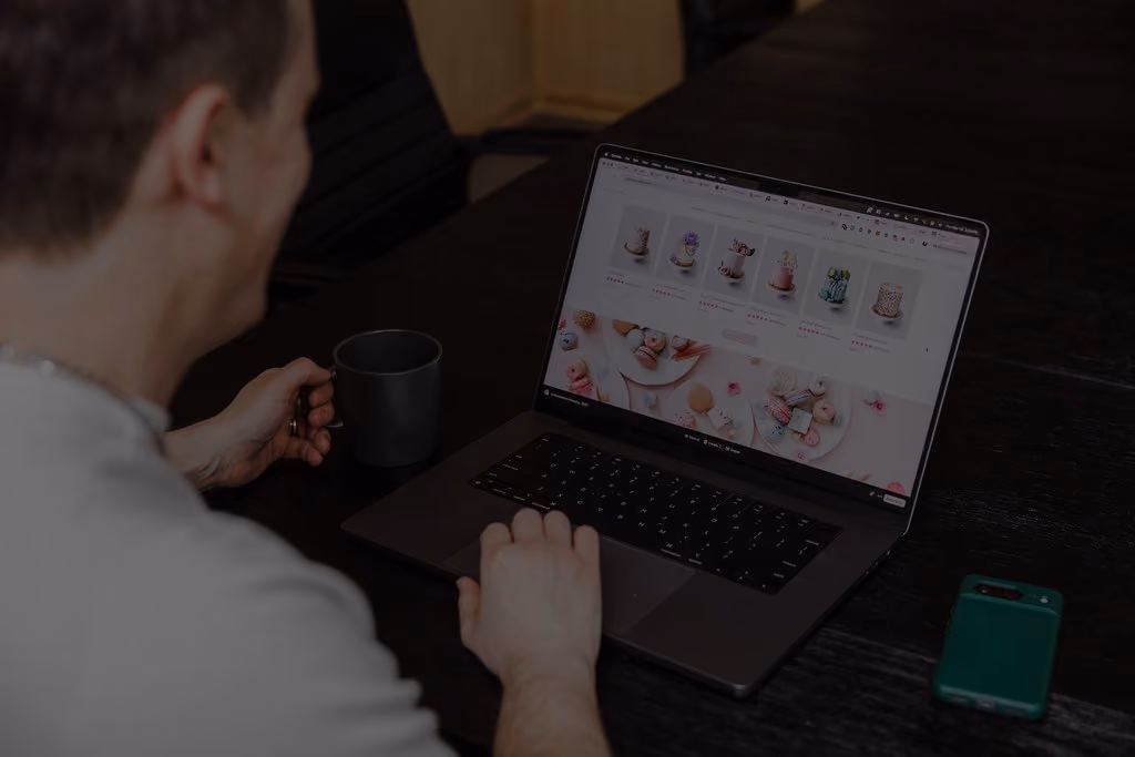 FireNet developer reviewing a Shopify storefront on a laptop.