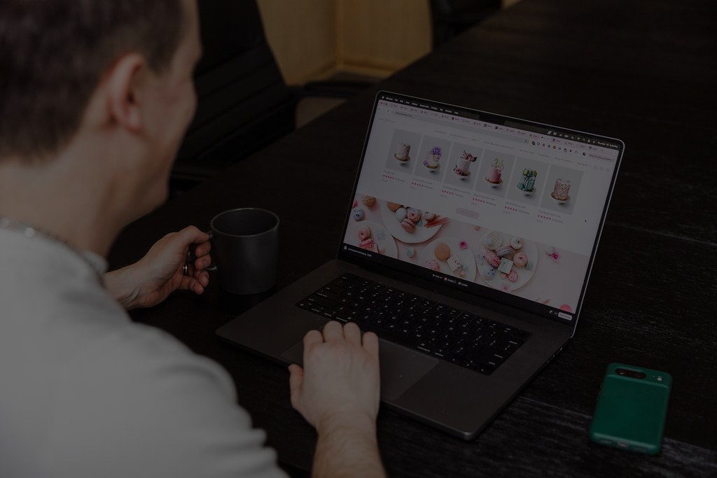 FireNet developer reviewing a Shopify storefront on a laptop.