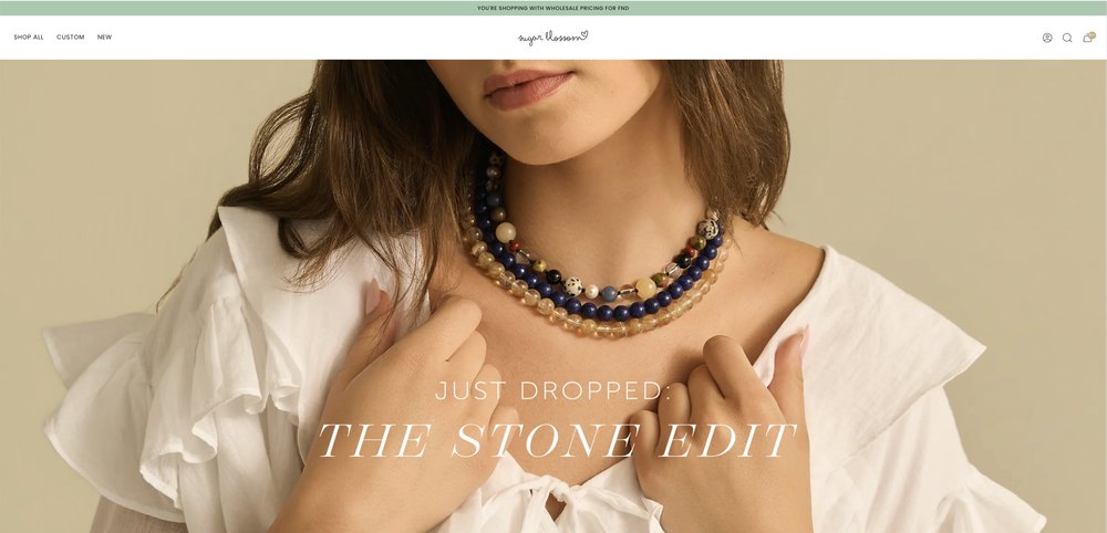 Sugar Blossom homepage logged in as a wholesale buyer, with a green wholesale pricing bar above the header.