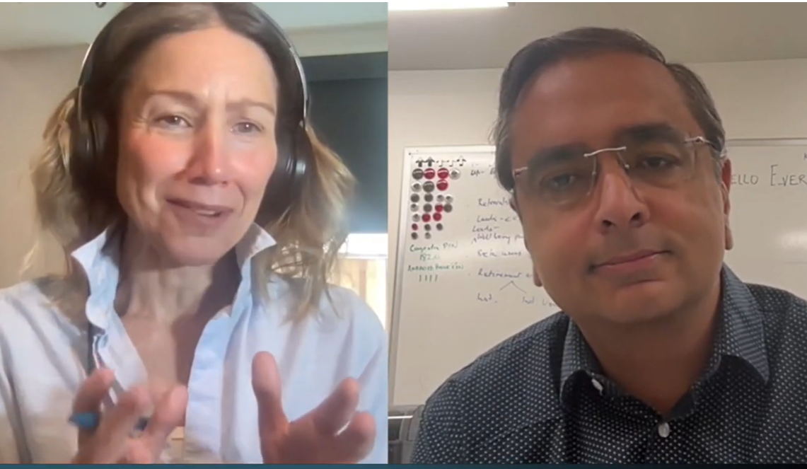 Two people engaged in a video call; a woman wearing headphones gestures with her hands while a man with glasses listens attentively.