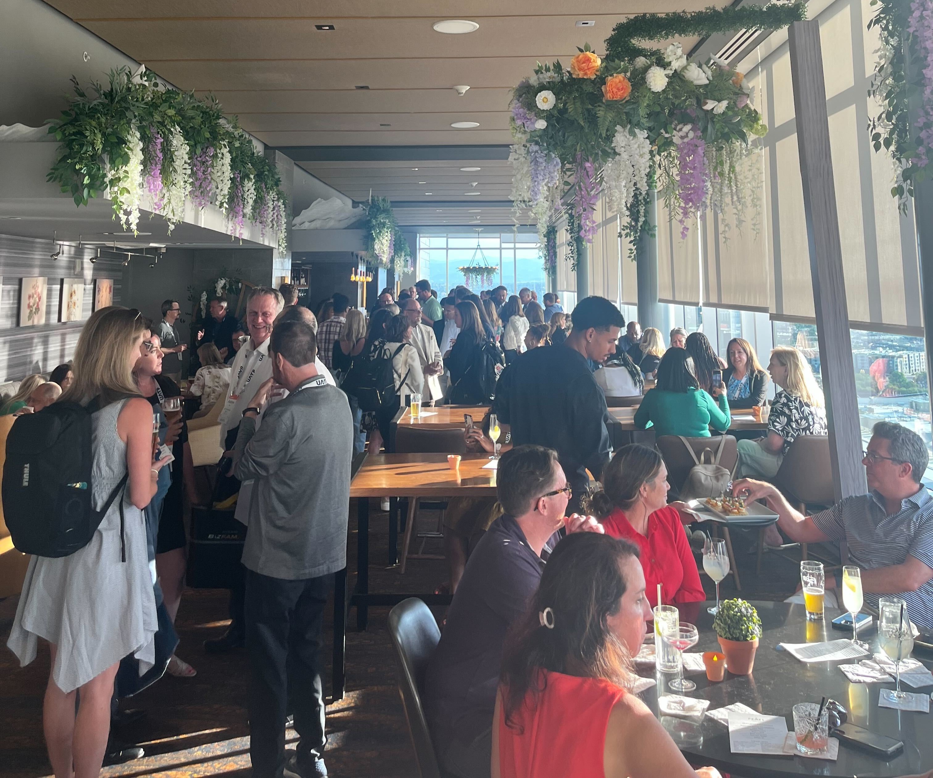 A packed out rooftop bar networking event