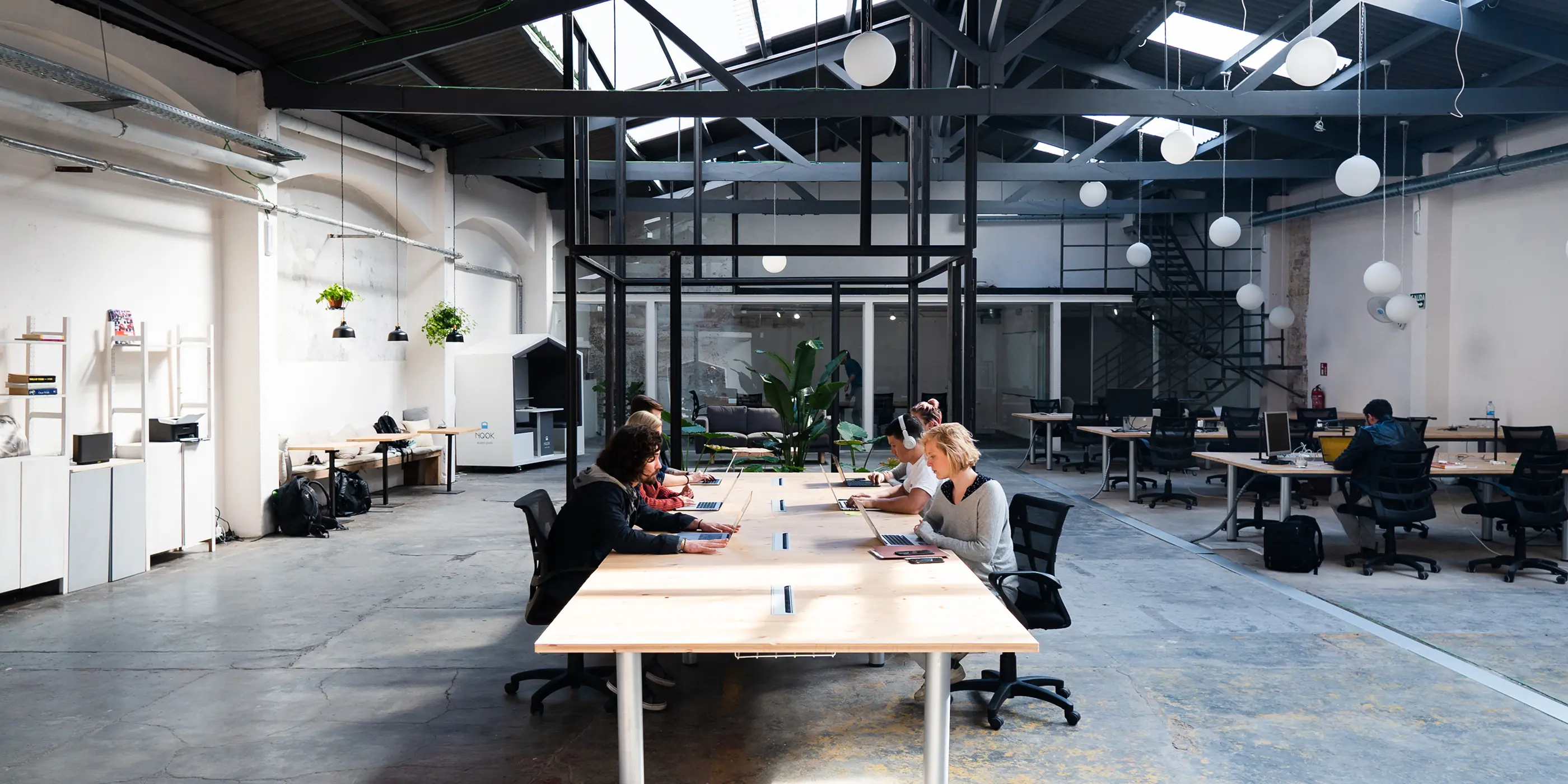 An open plan office with high ceilings and exposed beams