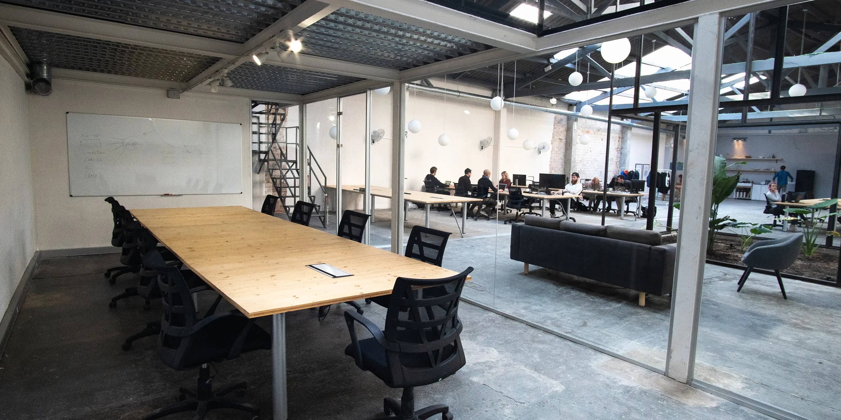 An empty meeting area with long shared tables