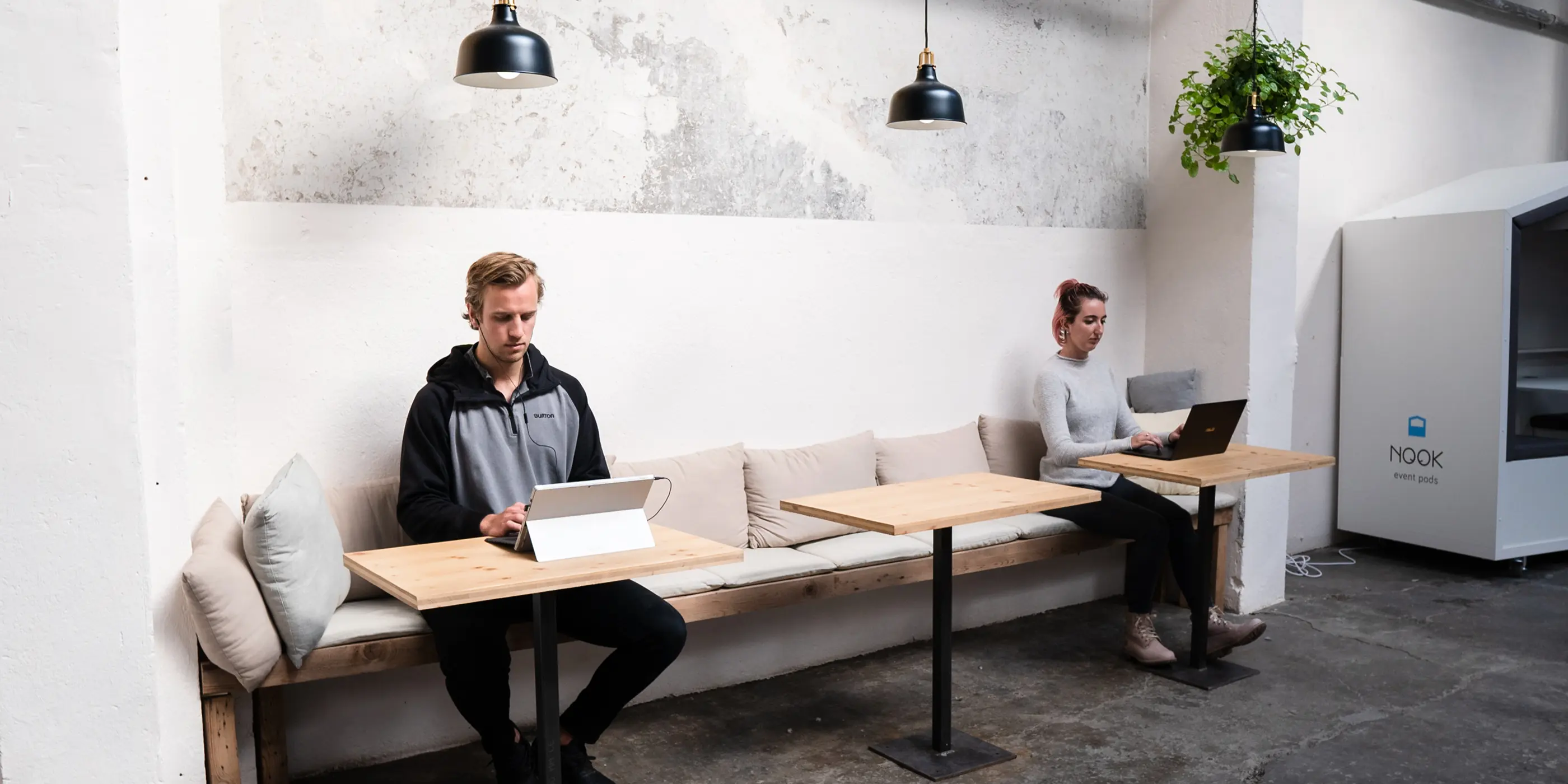 Colleagues working at long desks in a bright open office