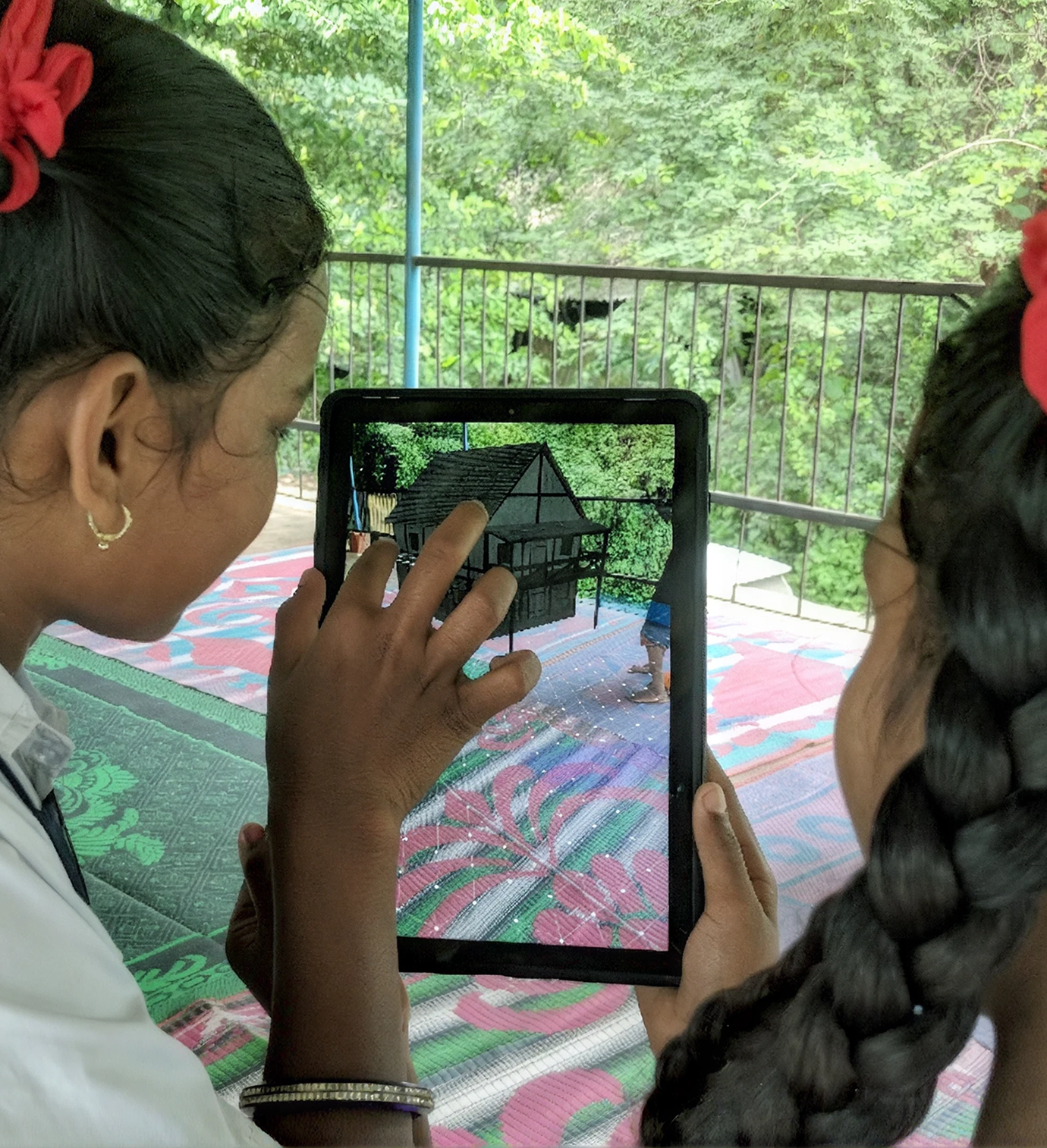 A student holding a tablet outdoors with an augmented reality model on the screen