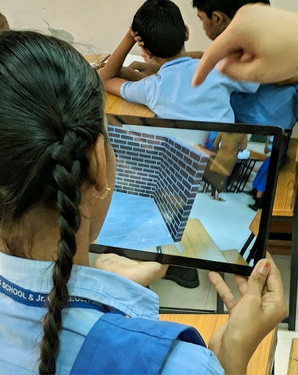 Students in blue uniforms working with tablets at classroom desks