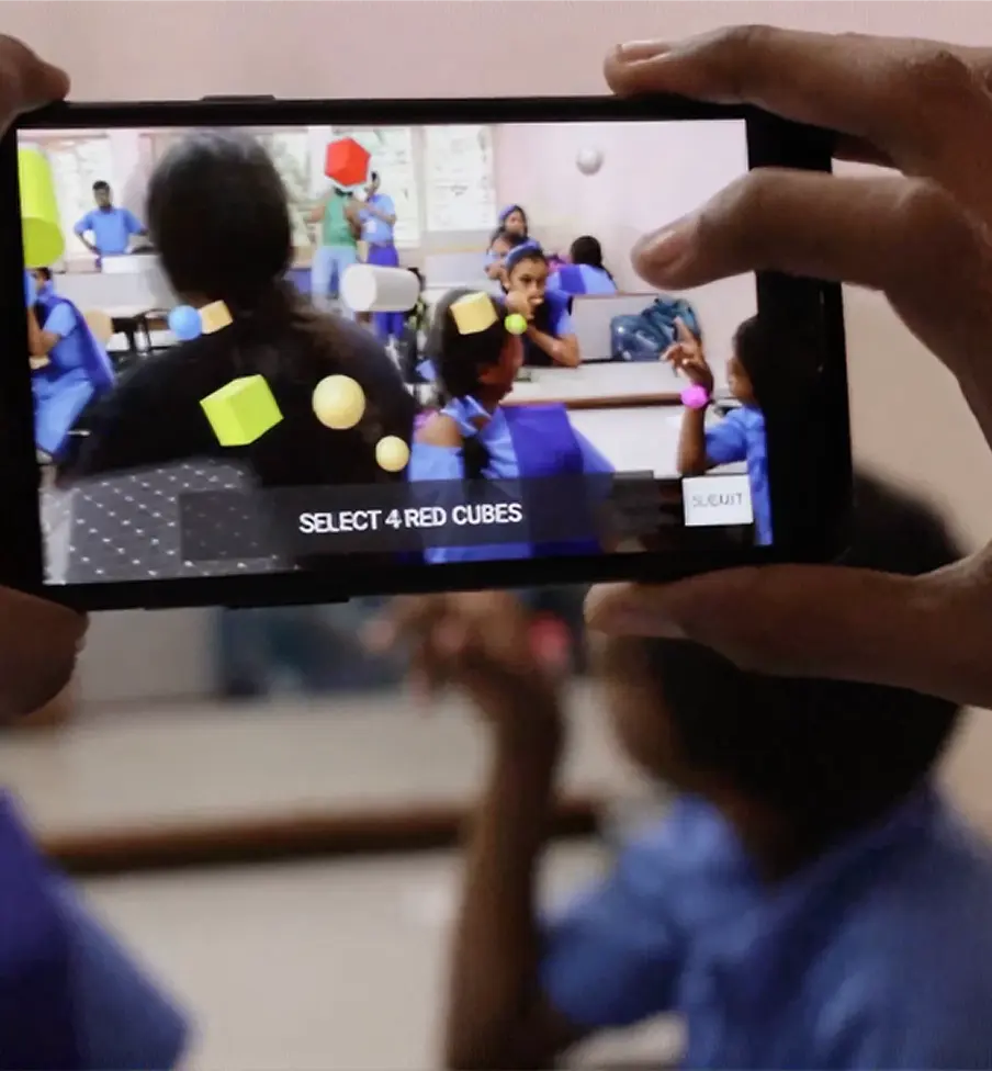 A phone held up in the classroom showing the augmented reality view