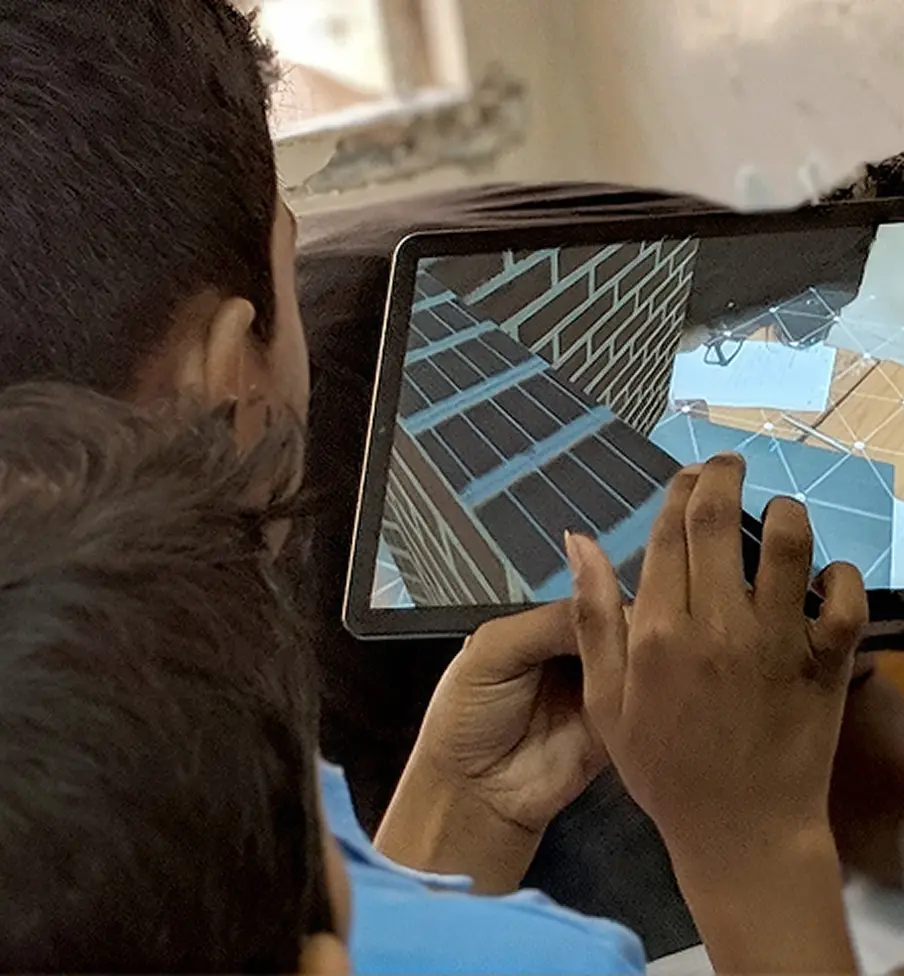 A student's hands using the augmented reality app on a tablet
