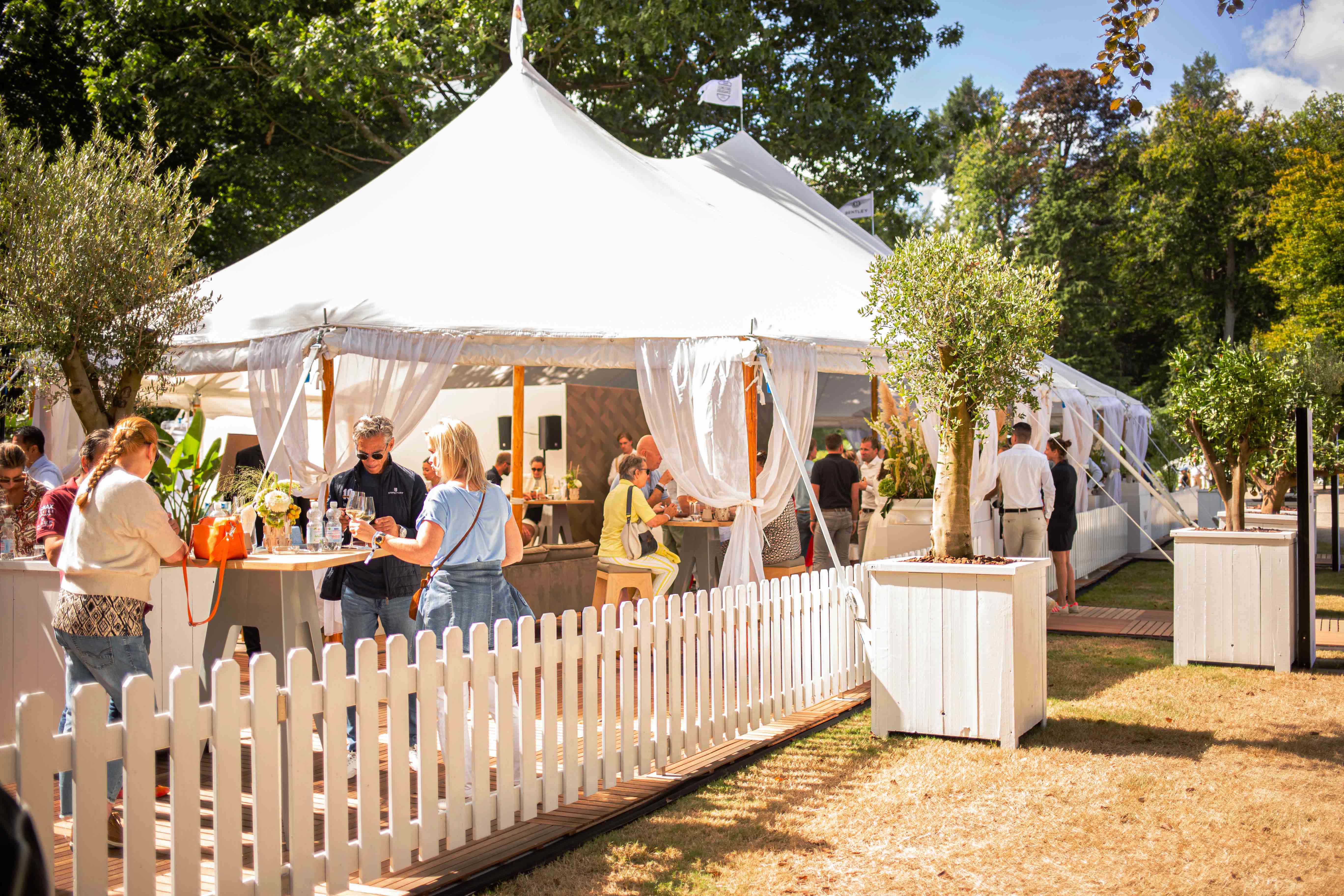 Gasten genieten in de besloten tuin van Club d'Elegance