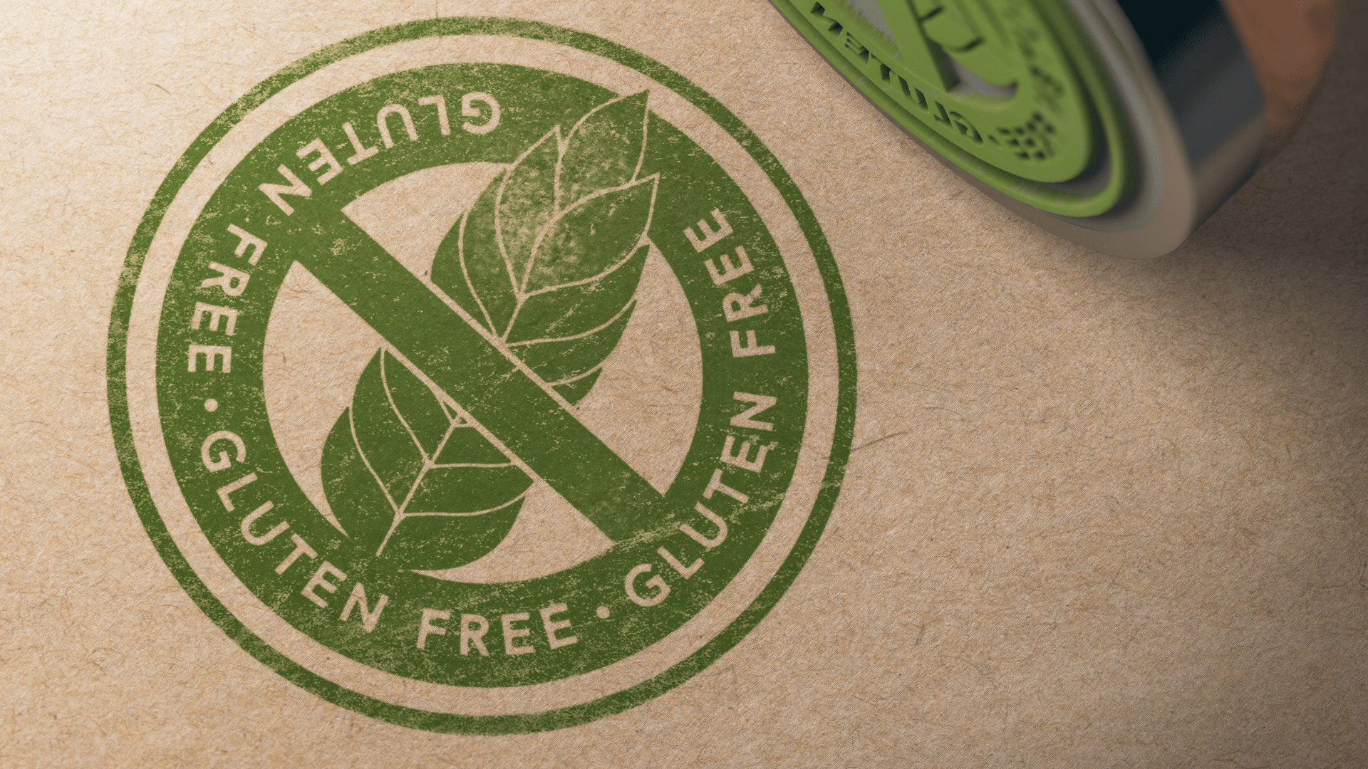 Green gluten-free stamp on kraft paper packaging, featuring a leaf icon crossed out.