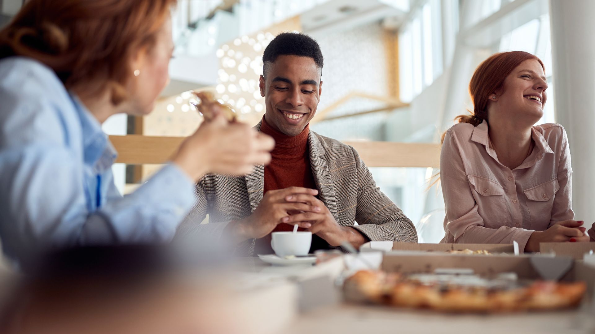 Team members sharing lunch during a relaxed workplace break.