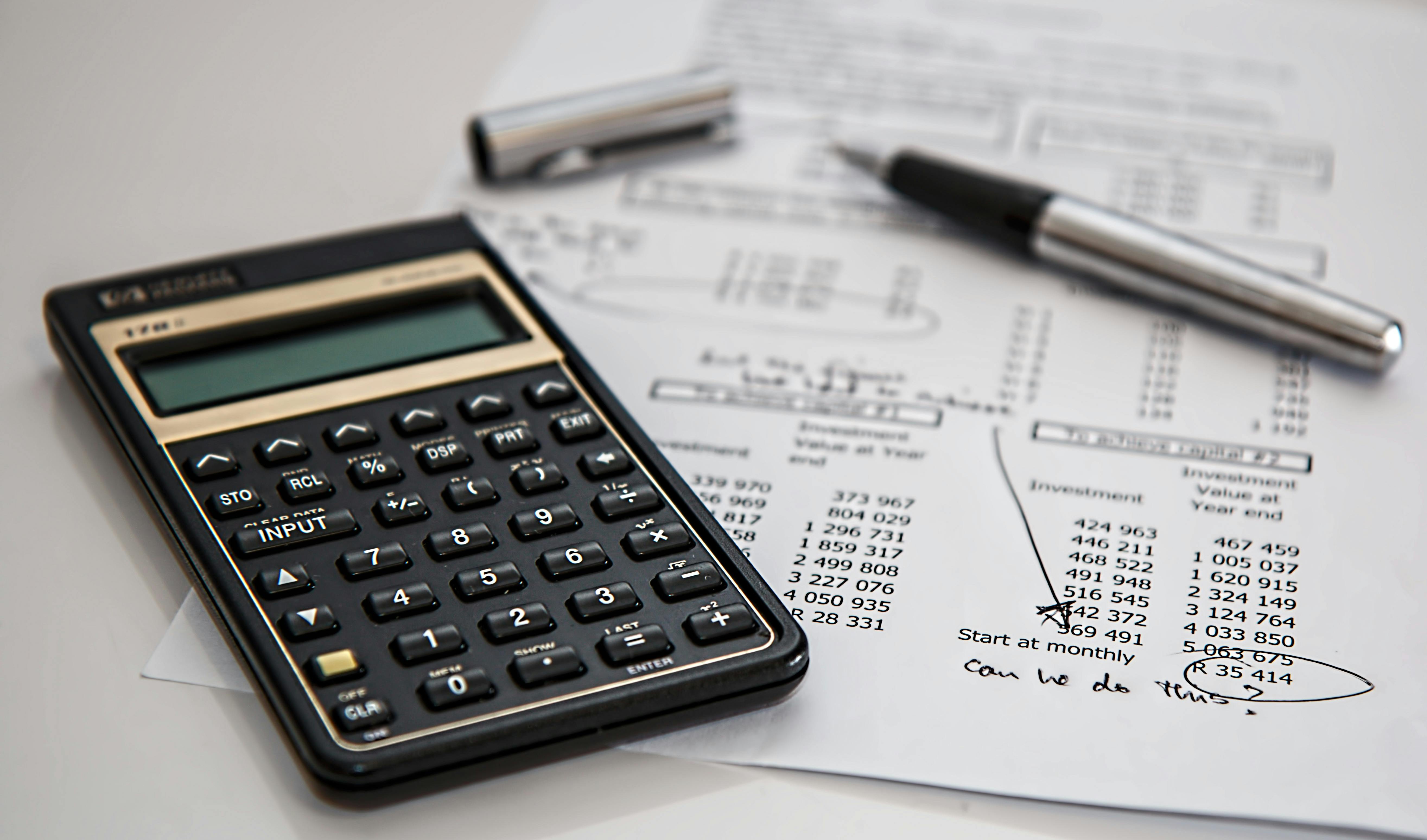A image showing a calculator and a paper used for accounting.