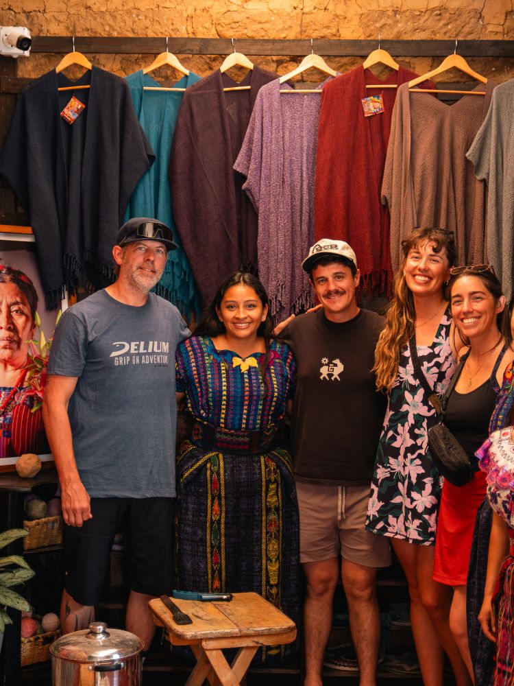 Mountain bikers learning about weaving techniques in San Juan Guatemala