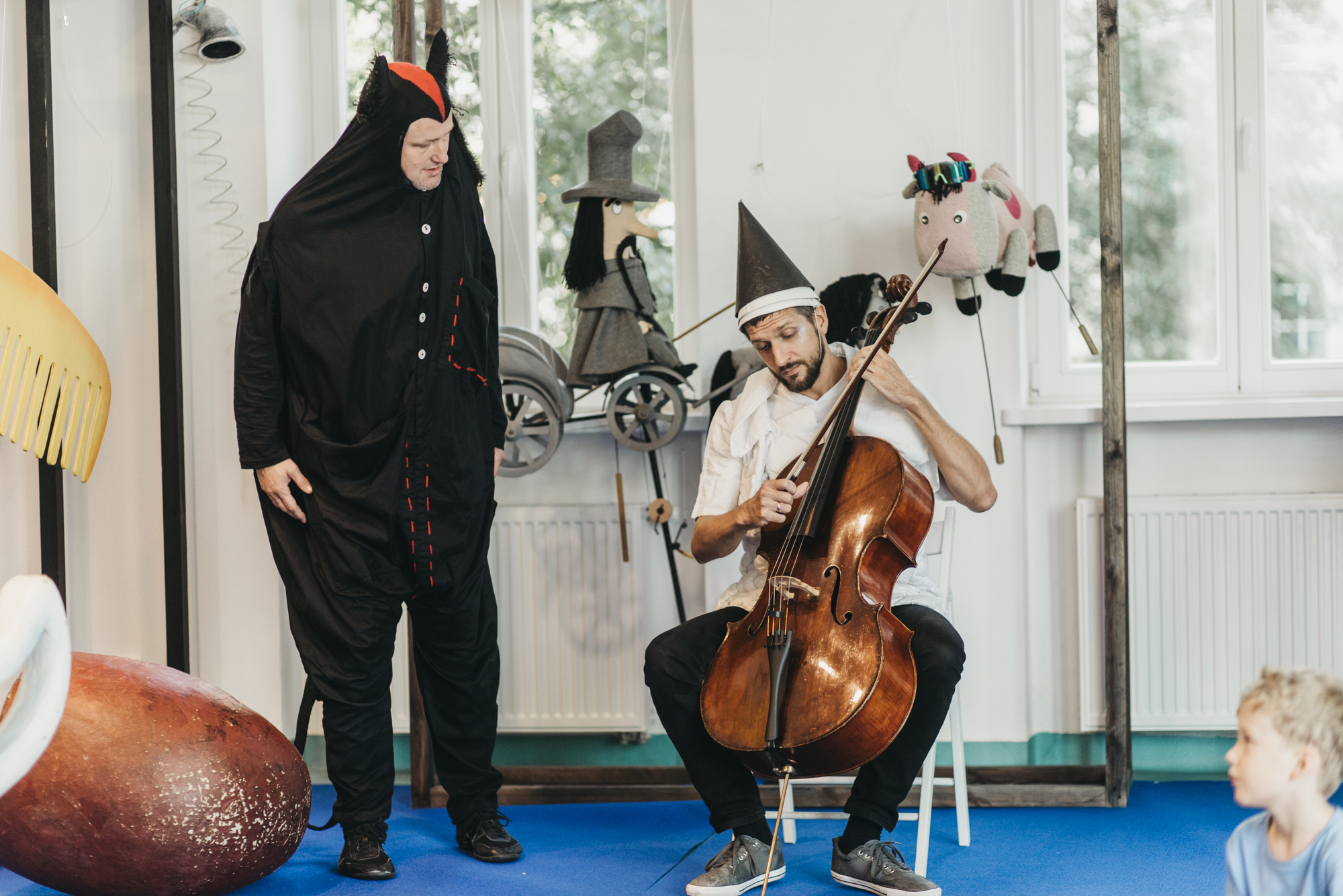 Aktor w ciemnym kostiumie i muzyk. Fot. Grzesiek Mart