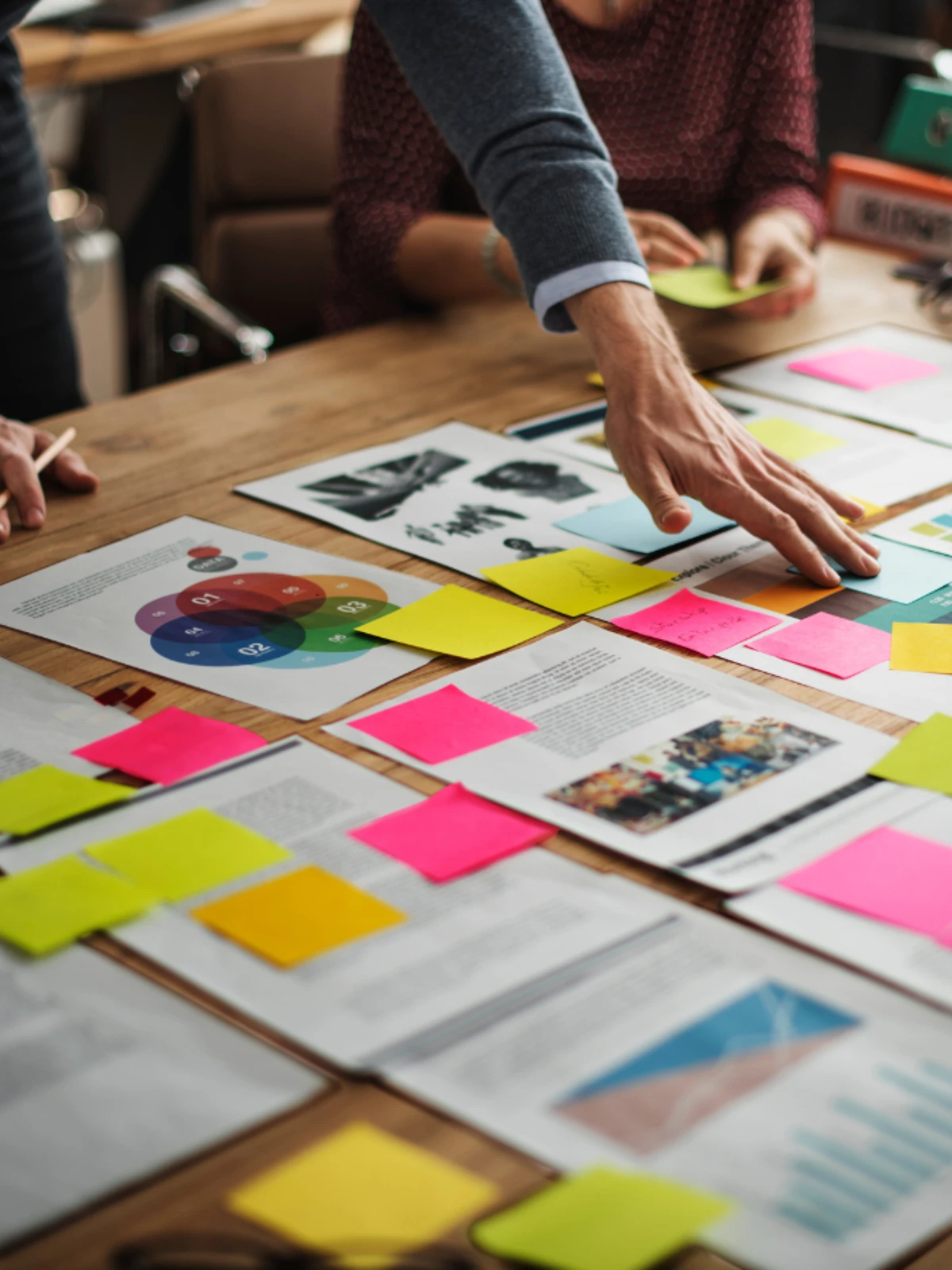 A brand strategy session with printed work and notes on a table