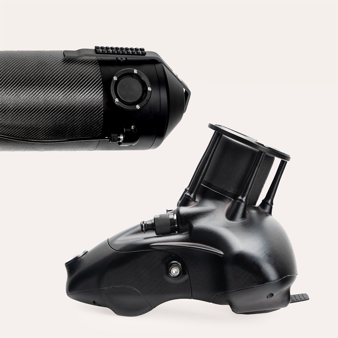 Close-up of two black mechanical components with smooth and textured surfaces on a white background.